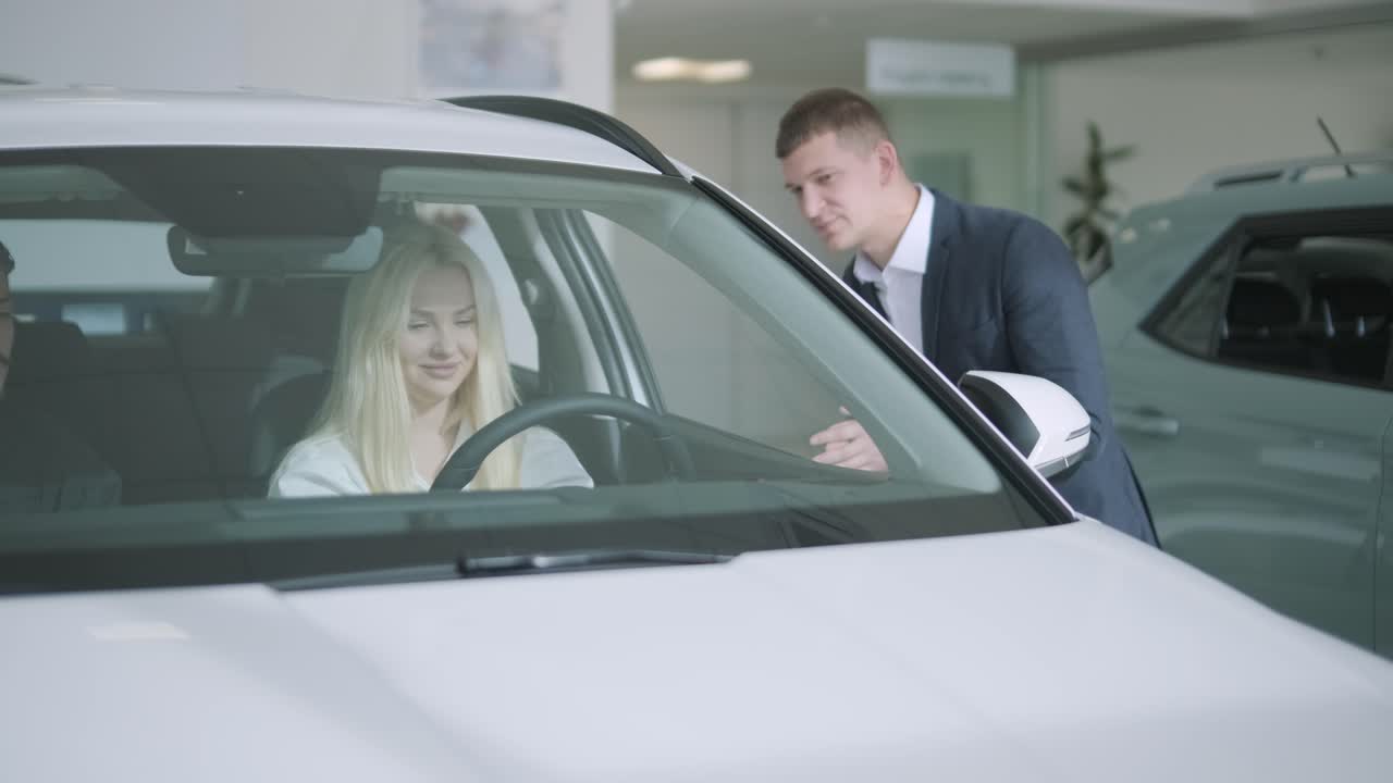 Customers buying a new car in a car dealership