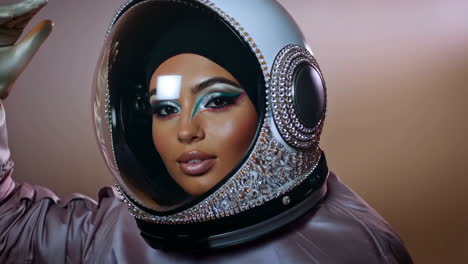 woman in embellished astronaut helmet with glamorous makeup