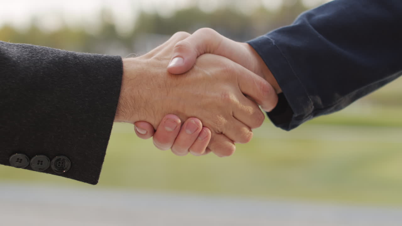 Two people shaking hands in agreement