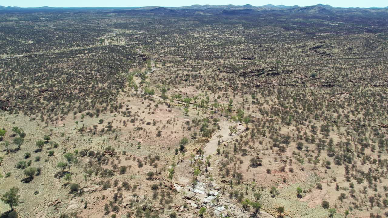 Reversing aerial footage of the dry Todd River and the Telegraph Station, north of Alice Springs, Mparntwe, Northern Territory, Australia. August 2022.