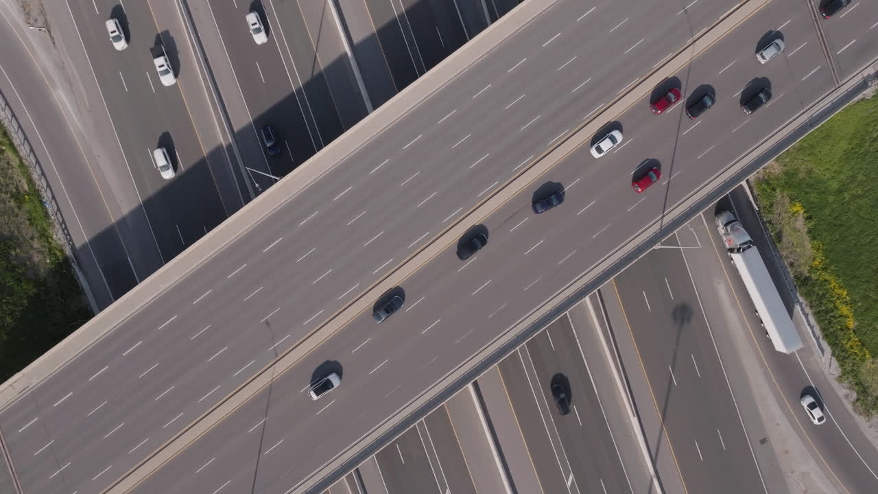 Cars moving slowly on Highway 401 overpass in Mississauga, Canada, aerial view