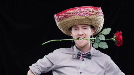 man with sombrero and rose