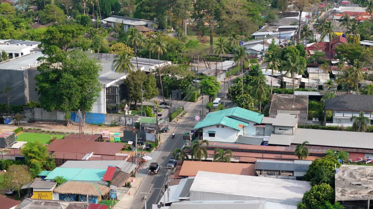 aerial drone footage of Koh Chang island, central Kai Bae village with roads, shops , hotel and accommodation
