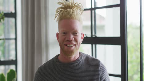 Portrait-of-happy-african-american-man-with-dreadlocks-in-house