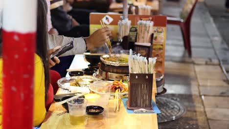 people eating and using phones at a restaurant