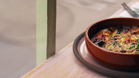 aubergine, feta and tomato bake in earthenware dish, pan