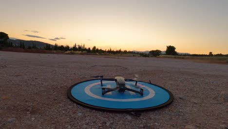 slow motion - dji drone mavic 2 pro taking off at sunset