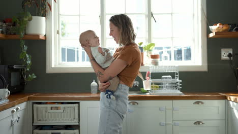 mother holding baby in kitchen