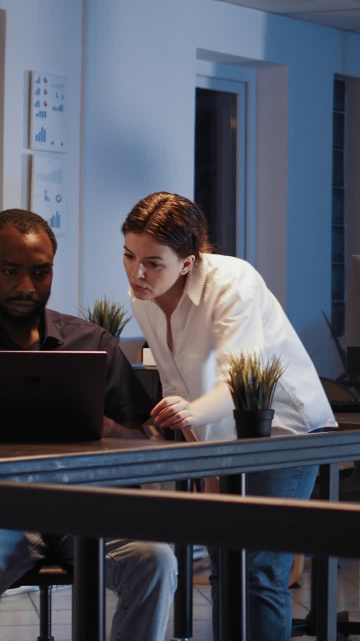 Vertical video: Diverse colleagues working in team to plan online presentation