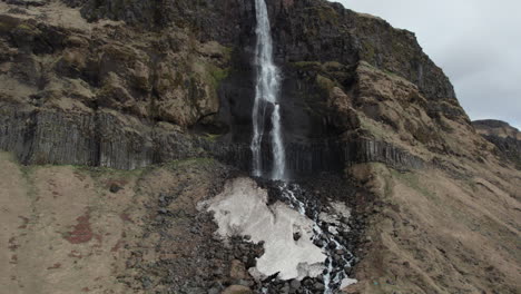 bjarnarfoss waterfall: aerial zoom-in shot of a fantastic icelandic waterfall