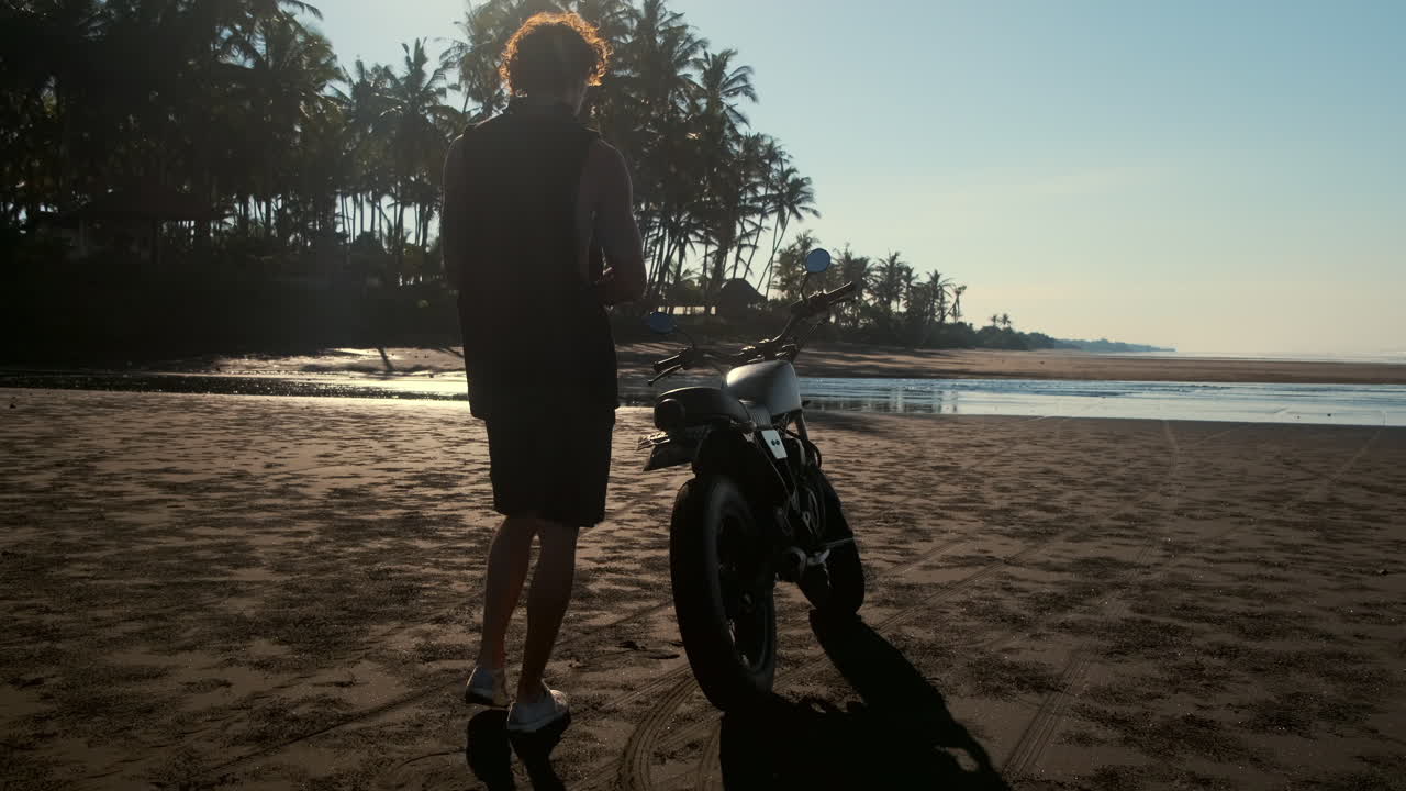 Man on a Motorcycle at a Tropical Beach Sunset