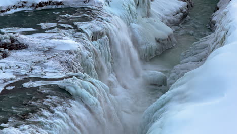 gullfoss waterfall in winter, canyon of the hvítá river iceland, spectacular water flow cascade descending into the gullfossgjúfur canyon surrounded by snow ice and frozen lands, glacial landscape