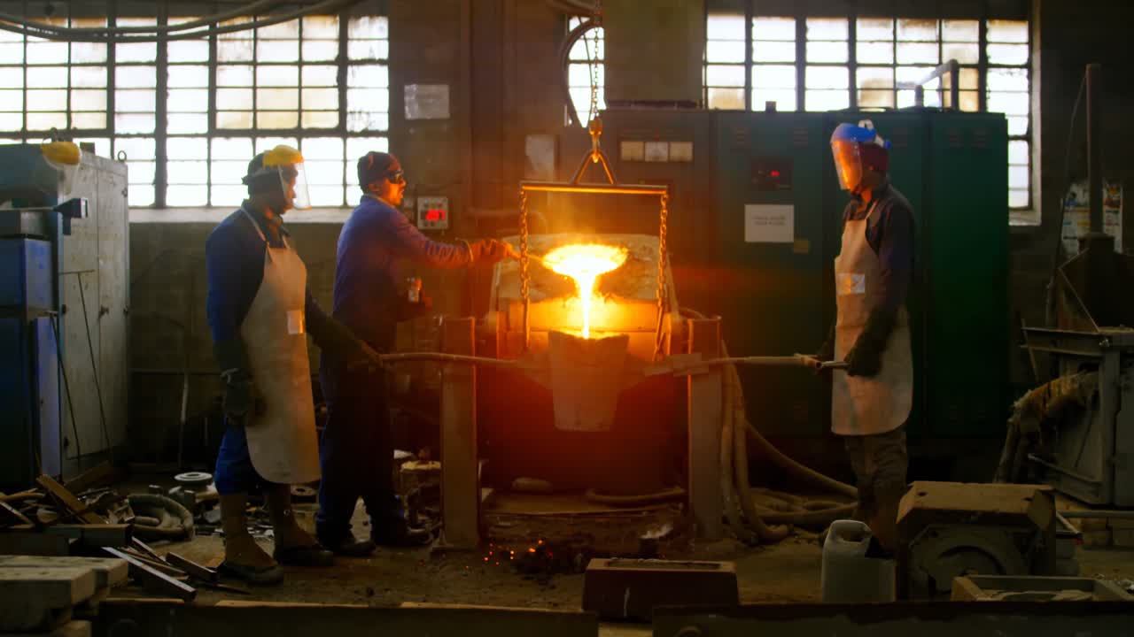 Worker pouring molten metal in container 4k