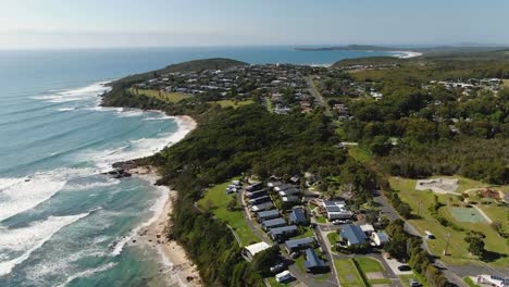 Aerial-view-of-Bonny-Hills-homes-lining-the-shoreline-in-New-South-Wales,-Australia