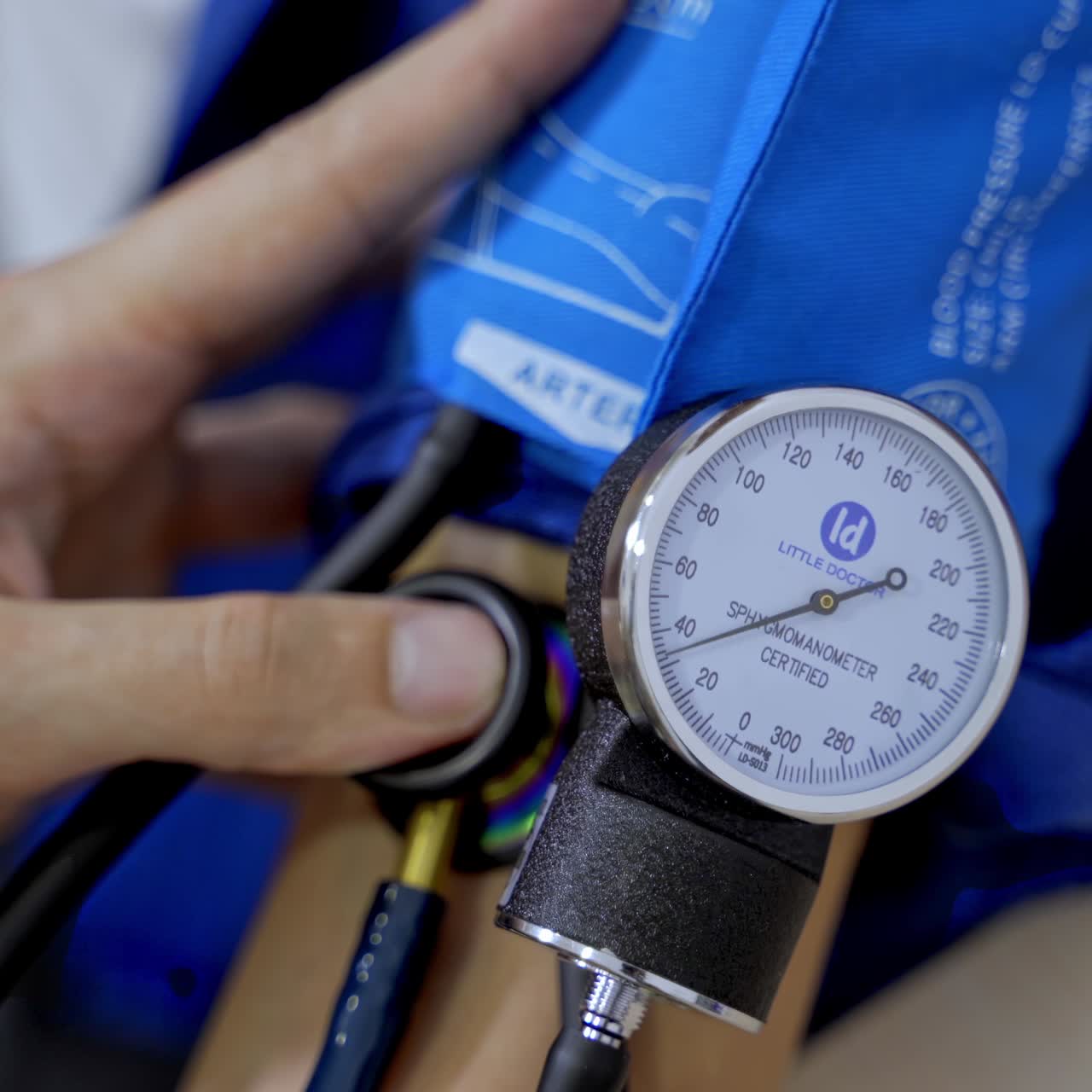 Measuring blood pressure at clinic front desk. Health care equipment. Consultation at clinic. Pressure measuring device. Selective focus on hand