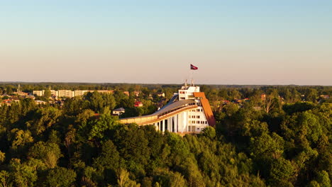 sigulda latvia: baltic travel, adventures, tours, landmarks, and attractions. 4k aerial circle around the historic olympic bobsleigh and luge track.