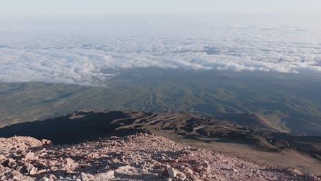 view of mountains, forests, clouds and a volcanic landscape during a sunrise in teide national park, tenerife, canary islands, spain.