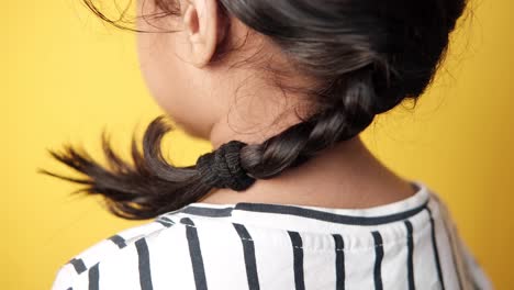 child with a braided ponytail