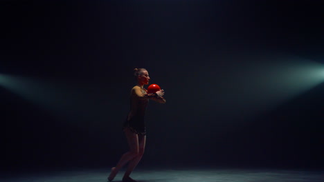 sports woman performing with ball indoors. flexible gymnast stretching inside.