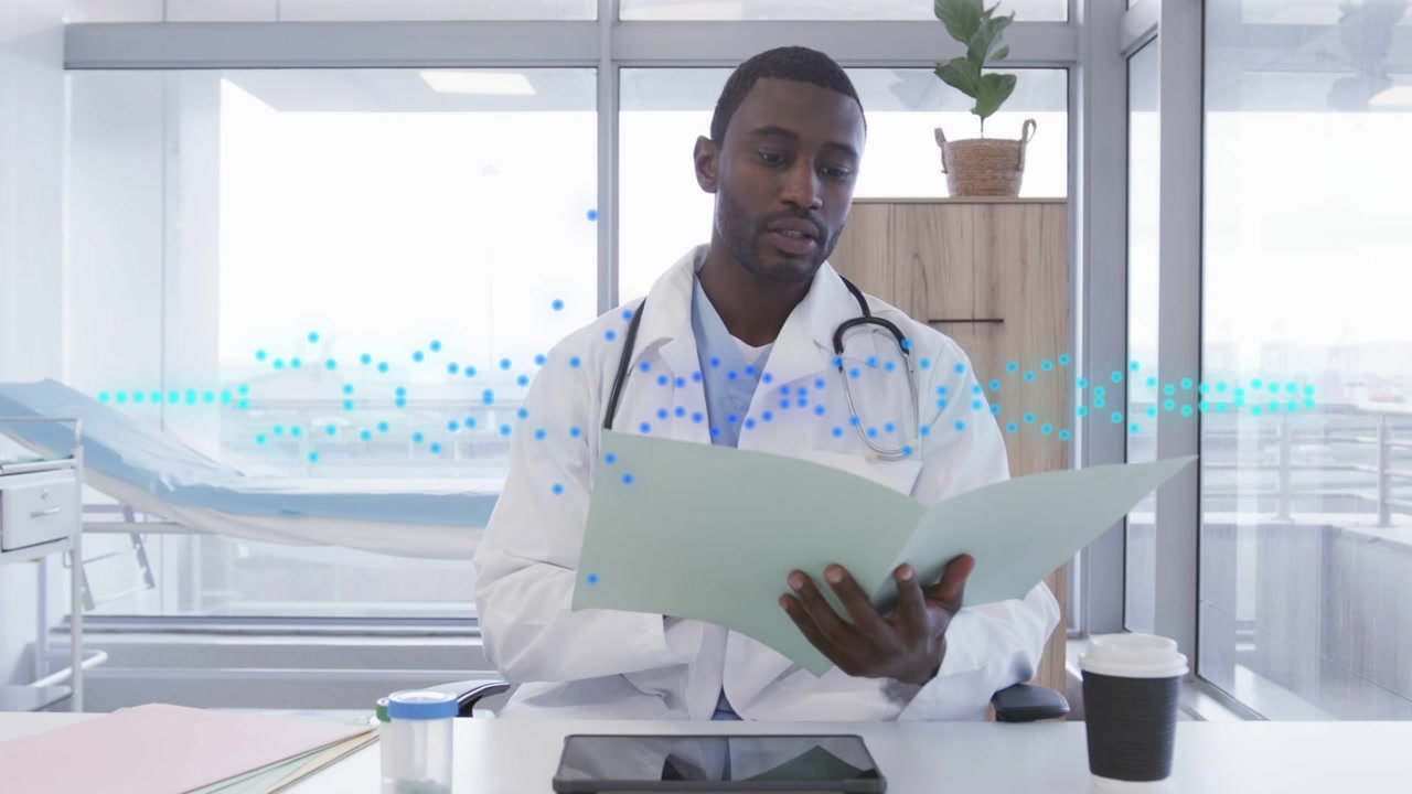 Dr opening green folder, reviewing notes at desk while blue waveform flagging data for medical care
