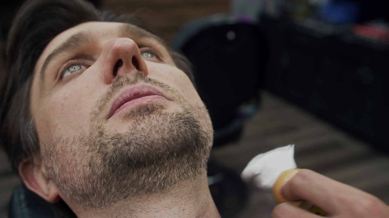 Man getting a shave at a barber shop