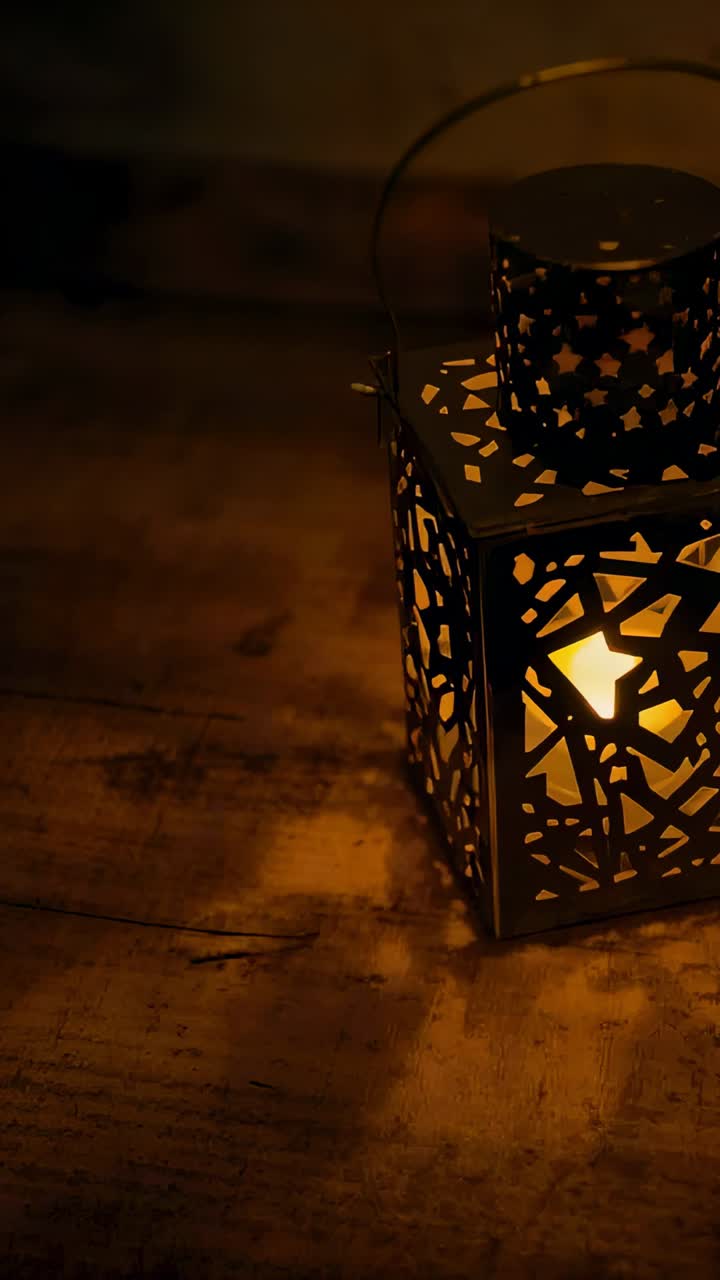Vertical video: Camera zooming metal lantern casting star shadows on worn wood by flame, copy space