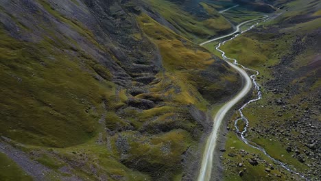 mountain pass, alpine valley, stream, rugged hills, kyrgyzstan aerial