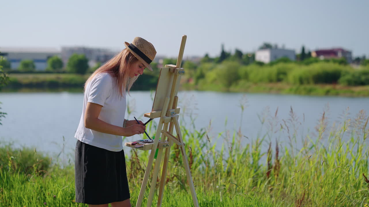 Woman Painting Outdoors by a Lake