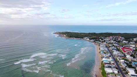 aerial view over ocean of seaside still bay west with harbor to the side