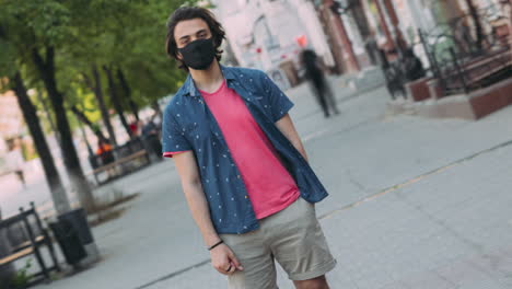 young man wearing mask in a city street