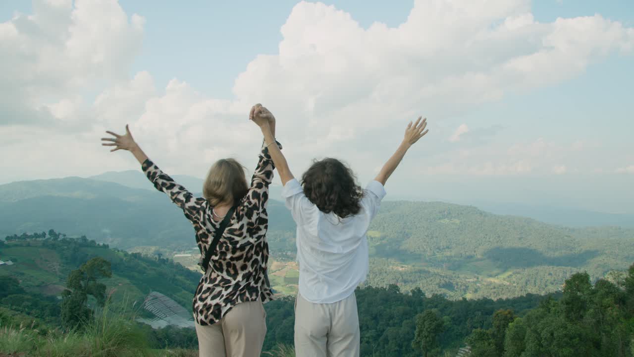 Two Women Celebrating a View from a Mountain