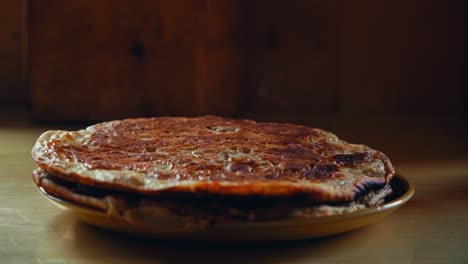 cinnamon and sugar are sprinkled over a stack of golden pancakes on a plate in reinsjøen, åfjord, trøndelag, norway - close up