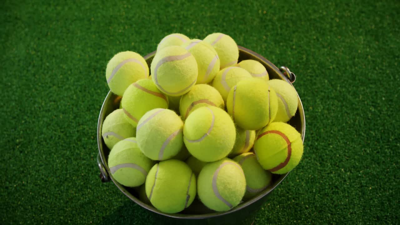 Tennis balls in bucket at studio 4k