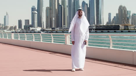 man in arabic clothing posing outdoors