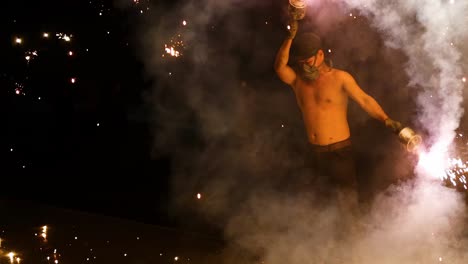 A performer skillfully manipulates fire, creating a captivating display of sparks and smoke.