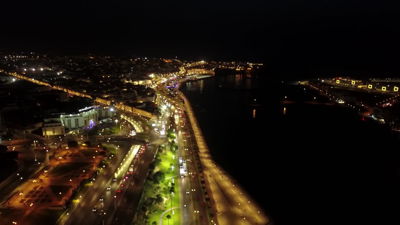 Rabat at night showcases vibrant streets and the iconic Hassan Tower by the Bouregreg River.