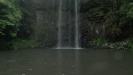millaa millaa falls on a rainy day in queensland, australia - tilt down shot