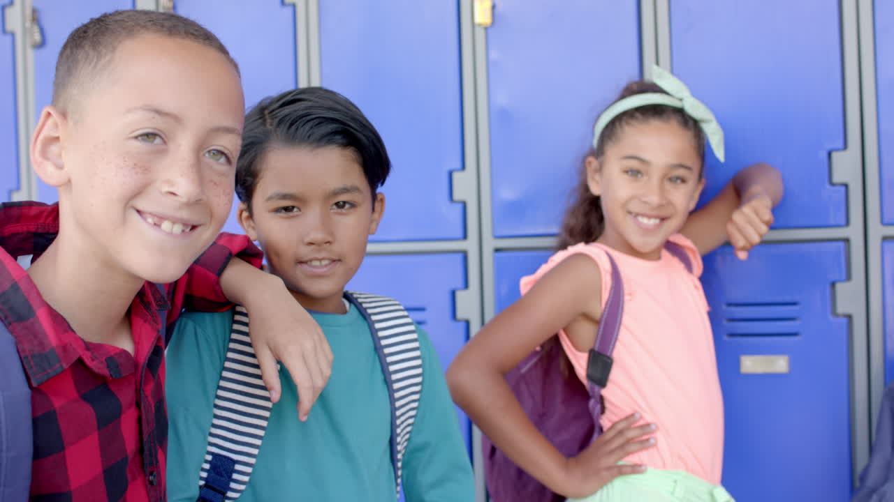Biracial boys and girl smile at school