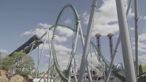 epic footage of a roller coaster being shot out of a tunnel into a series of loops and twists