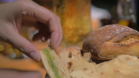 Beer-glass-and-eating-bruschetta-with-topping