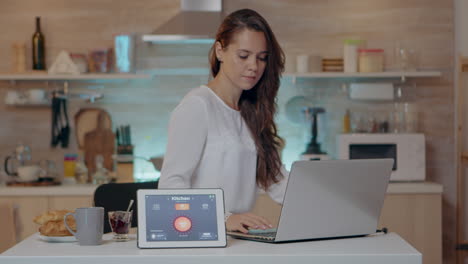 woman using voice activated smart wireless lighting app on tablet