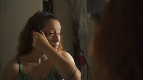 woman looking in mirror