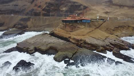 drone video of a rocky outcrop on the beach shore