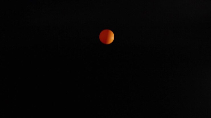 Orange ball bouncing against a dark background