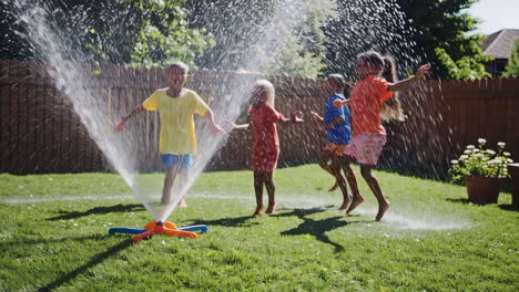 children playing with a water sprinkler
