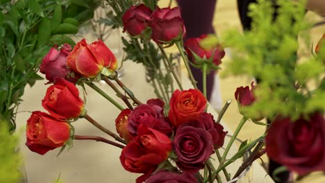 manos de floristas vistas mientras seleccionan flores para ramos y centros de mesa - movimiento giratorio