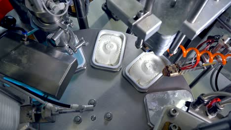 a round table with robotic equipment for cheese packing.