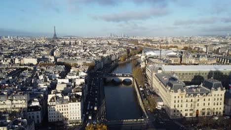 drone flying over the river seine in paris, with the eifel tower in the background on the left side