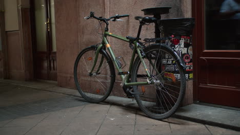 green bicycle parked on city street