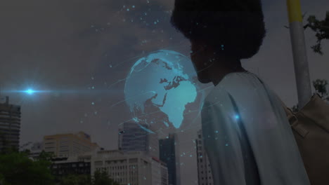 mid adult woman gazing at city skyline, showing holographic globe with padlock icons for tech